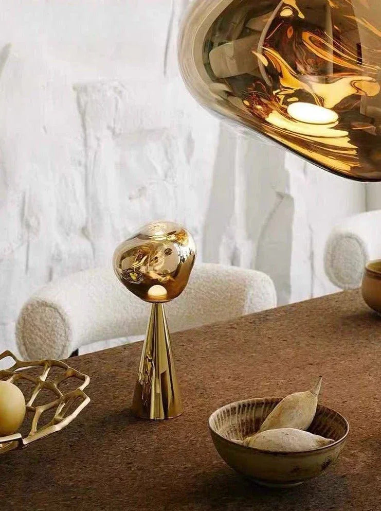 Modern melt-inspired LED lamp with softly rounded edges illuminating a bedside area.