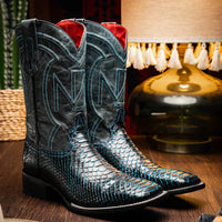 Lifestyle image of person wearing Missouri black and blue python skin cowboy boots.