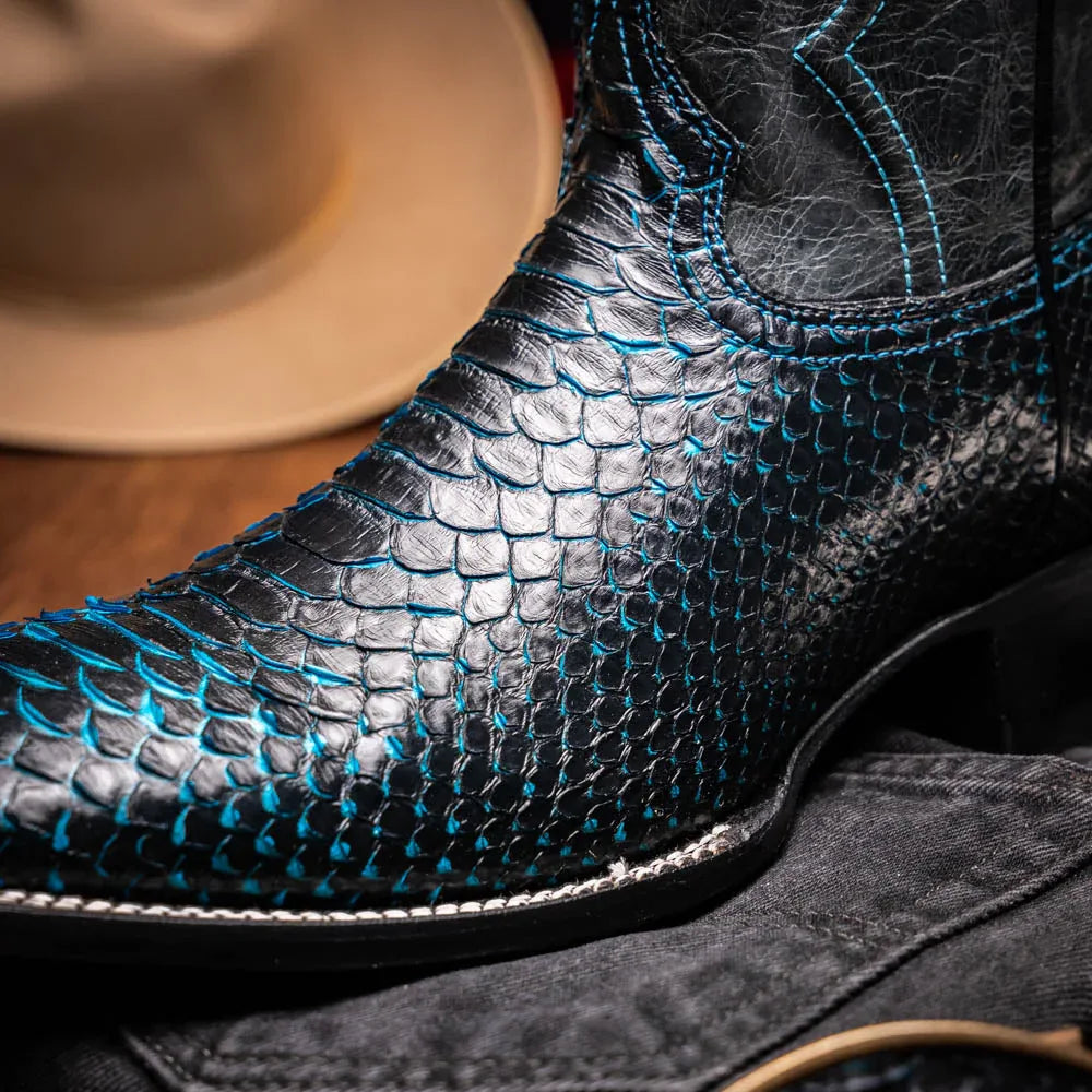 Man walking in Missouri black and blue python skin cowboy boots in urban setting.