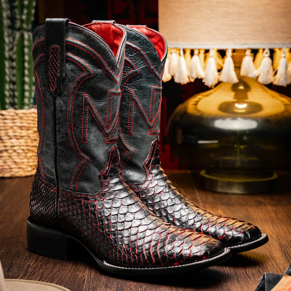 Lifestyle photo of Missouri BlackCherry python skin cowboy boot worn with dark jeans.