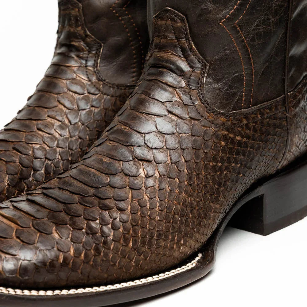 Missouri cowboy boot angled to show contrast between python skin vamp and smooth leather shaft.