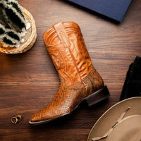 Walking scene featuring Missouri python skin cowboy boots in warm cognac color.