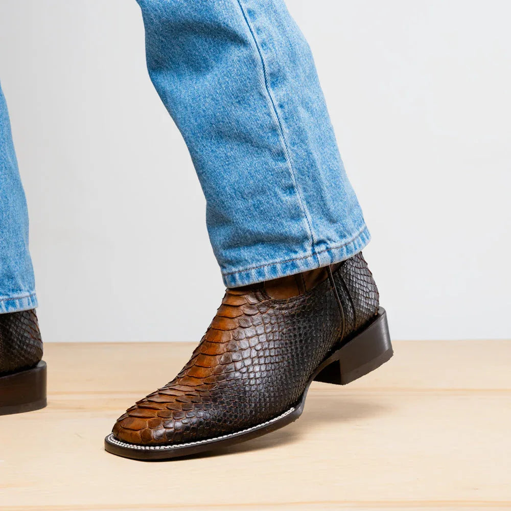 Close-up side profile of Missouri Lisboa python skin cowboy boot on foot, highlighting craftsmanship and design.