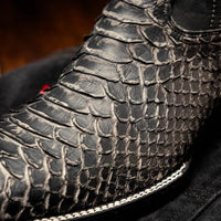 Missouri cowboy boots styled with rolled denim pants, emphasizing the exotic python texture.