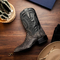 White python skin cowboy boots worn outdoors highlighting the premium craftsmanship and design.
