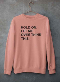Sweatshirt displayed showing sleeves and adjustable banded cuffs against concrete backdrop.