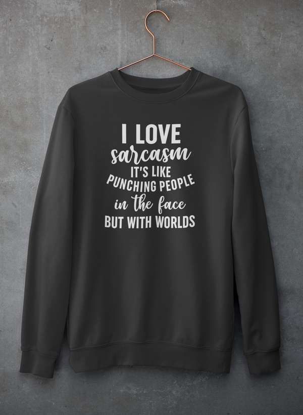 Gray crewneck sweatshirt hanging against a concrete wall, displayed front view.