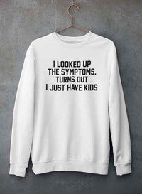 Close-up of gray sweatshirt with humorous kids-related text printed on front, hanging against wall.