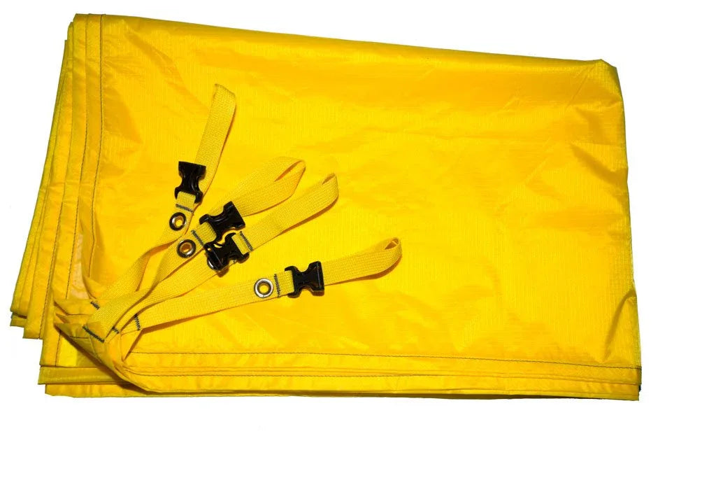 Blue Trail 43 4P footprint spread flat, showing ripstop nylon material and buckles on grass