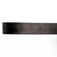 Montana belt’s antique brass buckle and matching tip on textured black leather belt.