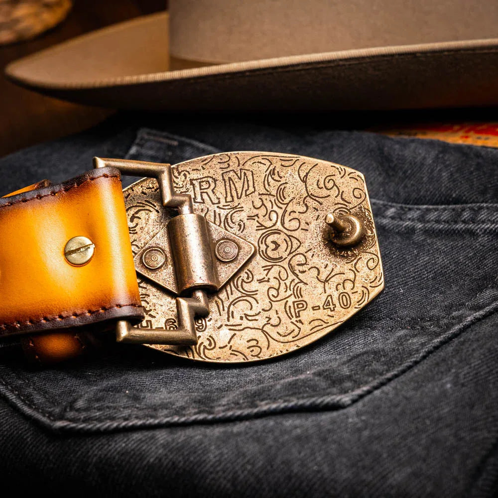 Montana Belt worn with rolled-up pants, highlighting belt’s texture and antique brass hardware.