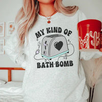 White sweatshirt featuring My Kind Of Bath Bomb colorful graphic design on the chest