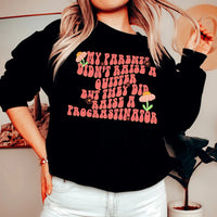 Black sweatshirt with white text saying 'My Parents Didn't Raise A Quitter' in bold font.