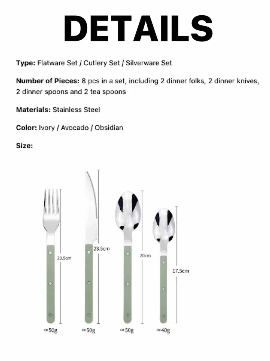 Stainless steel cutlery set with ivory handles laid out on a rustic wooden table in natural light.