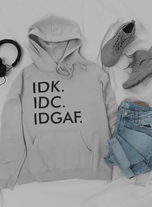 Flat lay of hoodie with adjustable hood, paired with casual sneakers and jeans outfit.