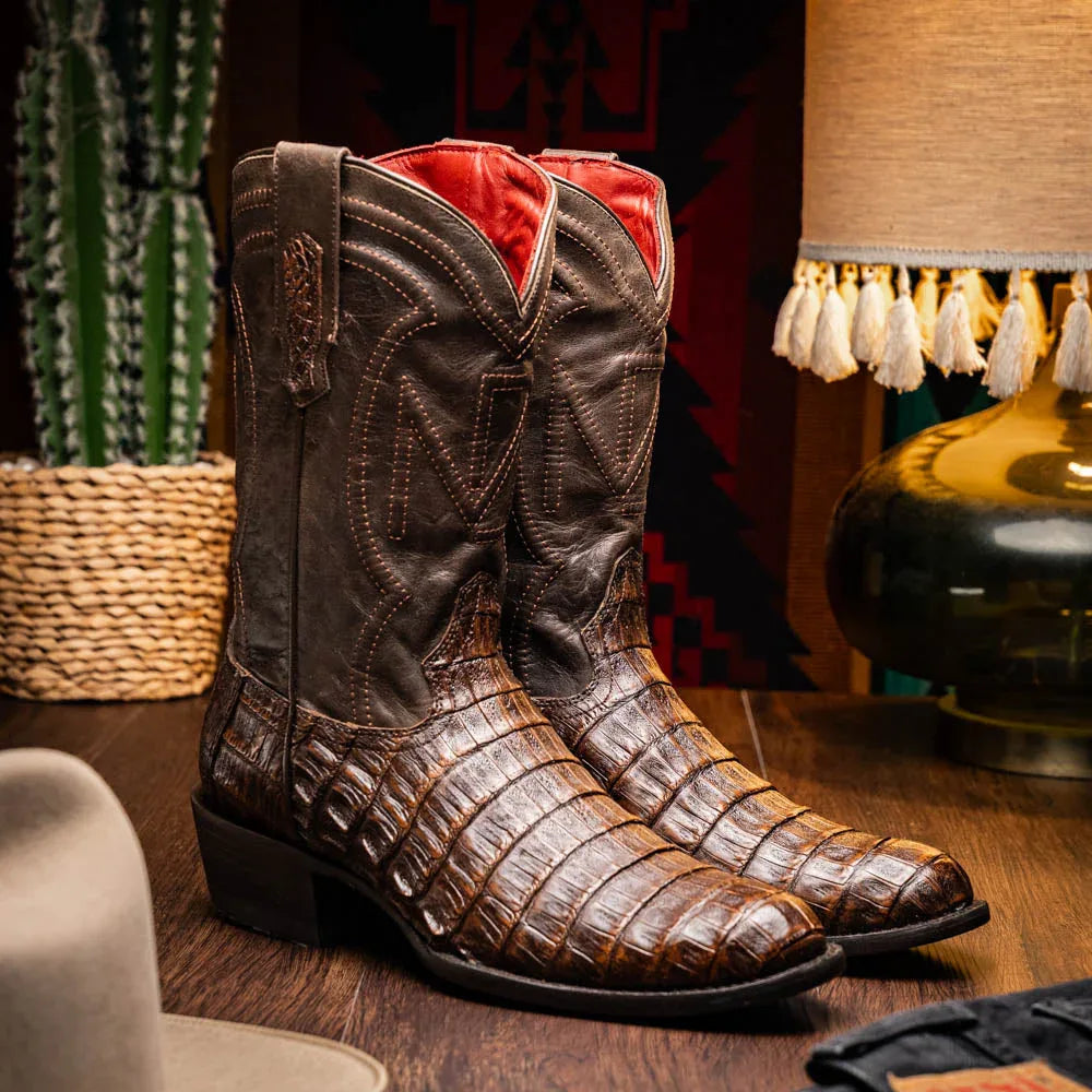 Lifestyle image of man wearing Phoenix Aged Brown caiman skin cowboy boots with jeans.