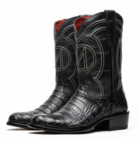 Detail of scale pattern on black caiman belly skin cowboy boot with round toe