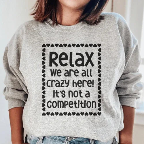 Close-up of sport grey 'Relax We Are All Crazy Here' sweatshirt showing fabric texture and cuff detail.