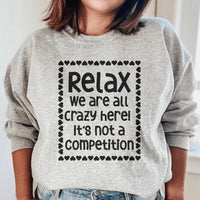 Close-up of sport grey 'Relax We Are All Crazy Here' sweatshirt showing fabric texture and cuff detail.