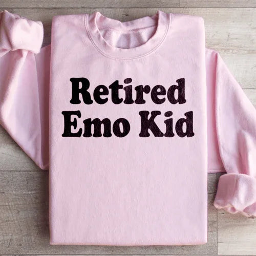 Light pink sweatshirt with 'Retired Emo Kid' print, adjustable cuffs for heat retention.
