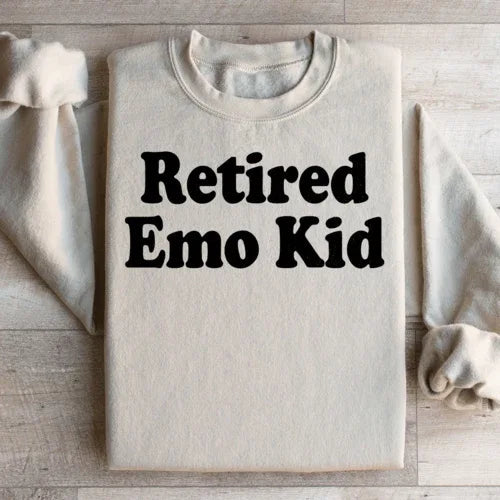Sand-colored fleece sweatshirt with 'Retired Emo Kid' graphic, super warm and cozy.