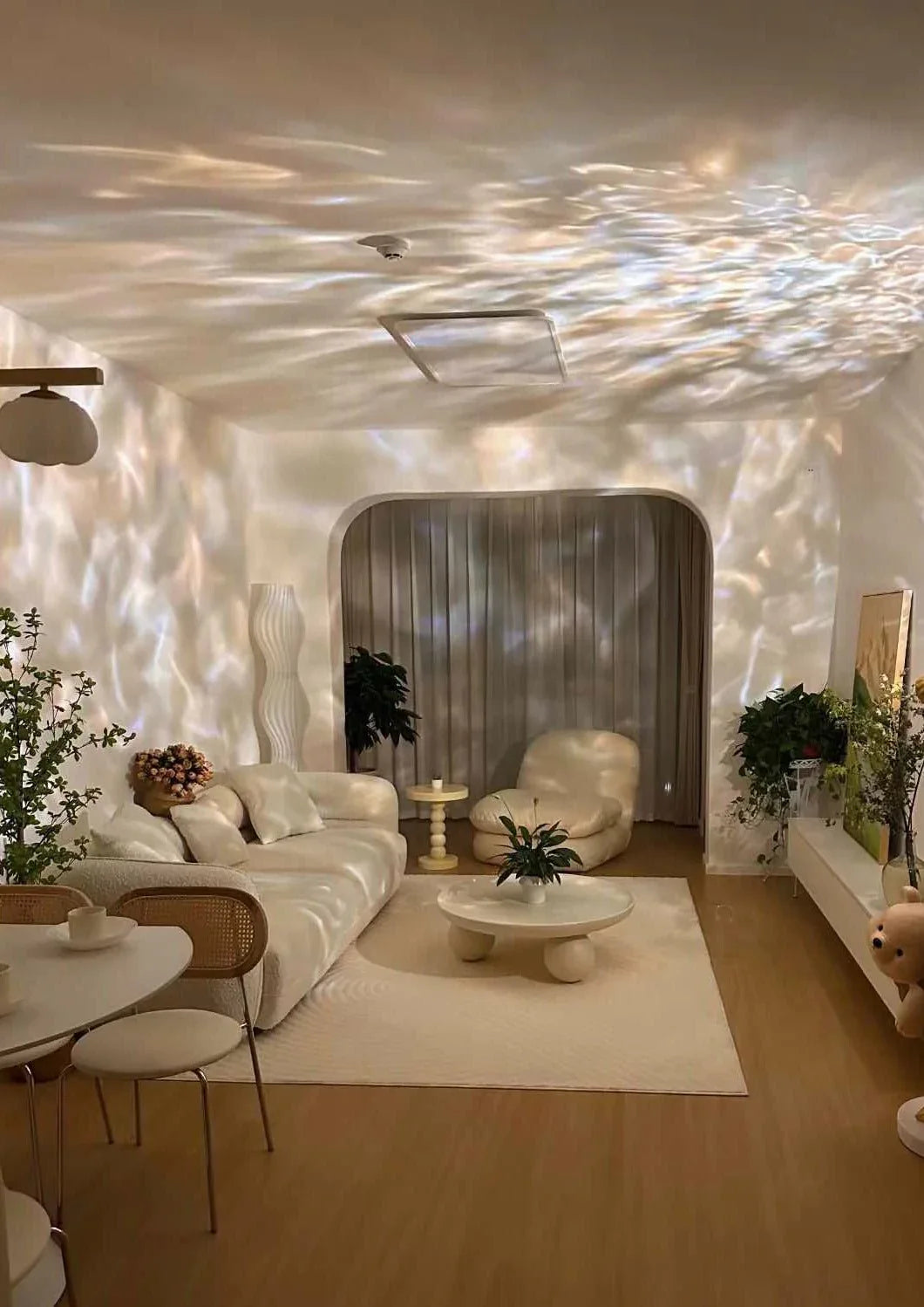 Ripple projector table lamp casting dynamic ambient light with sparkling wave patterns on wall.