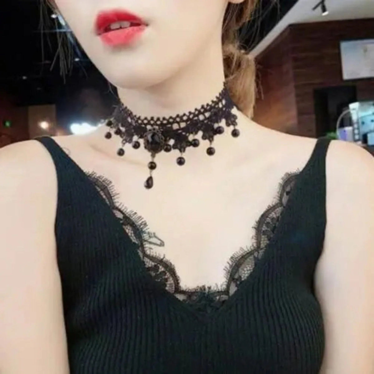 Black fashion lace necklace displayed on a mannequin bust against white backdrop.