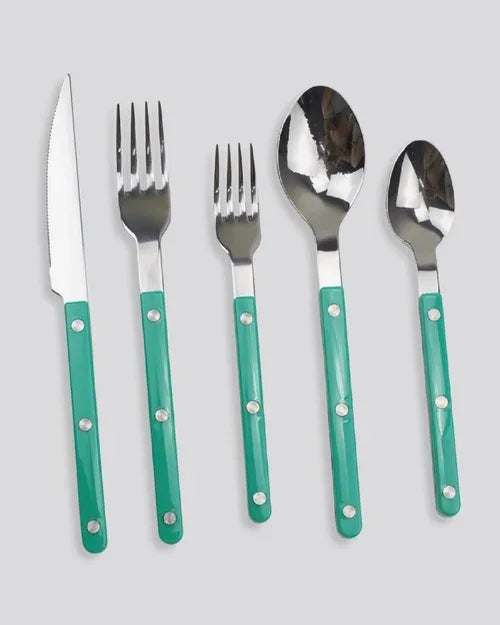 Elegant turquoise bistrot style cutlery laid out on a dark slate surface.