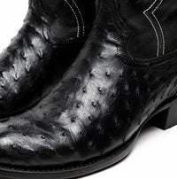Side angle of Savannah black ostrich skin cowboy boot highlighting red lining inside.