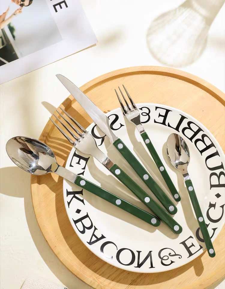 Top-down view of French bistrot style dopamine cutlery set arranged neatly on a flat surface.