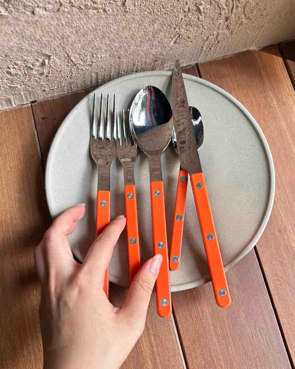 Polished stainless steel French dopamine flatware with a simple and elegant design on display.