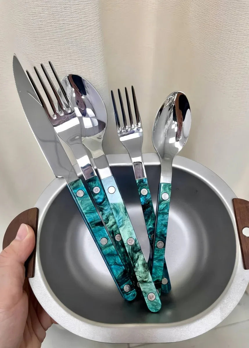 Silver modern flatware neatly displayed on a clean white background