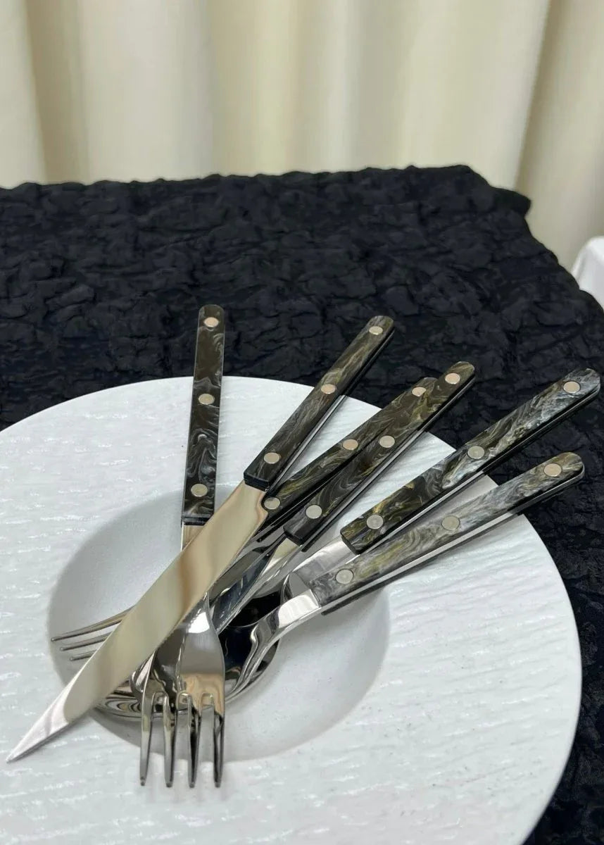 Top view of bistrot style cutlery including forks, knives, and spoons