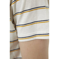 Model adjusting sleeve of Edgar Striped Tee showing fabric stretch and comfort.