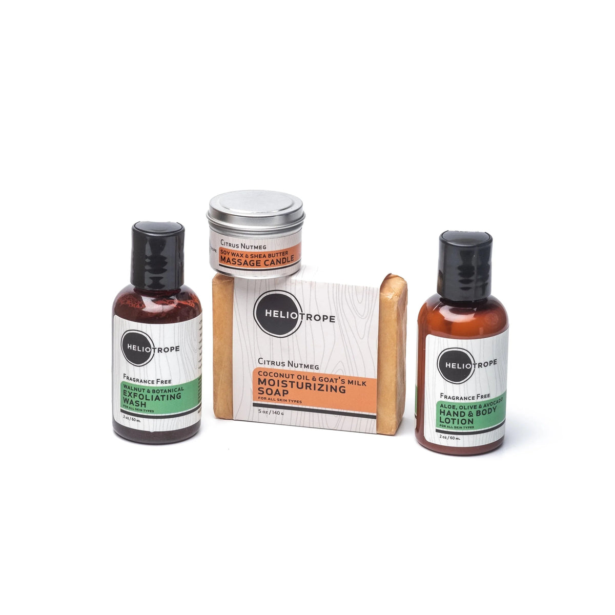 Small basket holding travel-sized body lotion, shower gel, goat's milk soap, and a mini massage candle from the Heliotrope