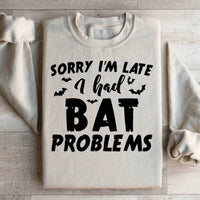 Sand-colored sweatshirt with Sorry I'm Late I Had Bat Problems text in white on front.
