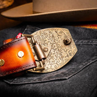 Lifestyle shot highlighting textured leather and antique buckle of Texas Western belt.