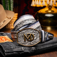 Lifestyle shot of model wearing gray Texas caiman and calfskin belt with Western buckle.