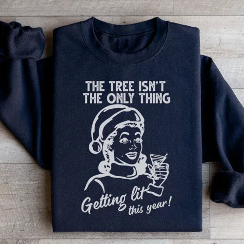 Black sweatshirt showing the slogan 'The Tree Isn't The Only One Getting Lit This Year' in bold typography.