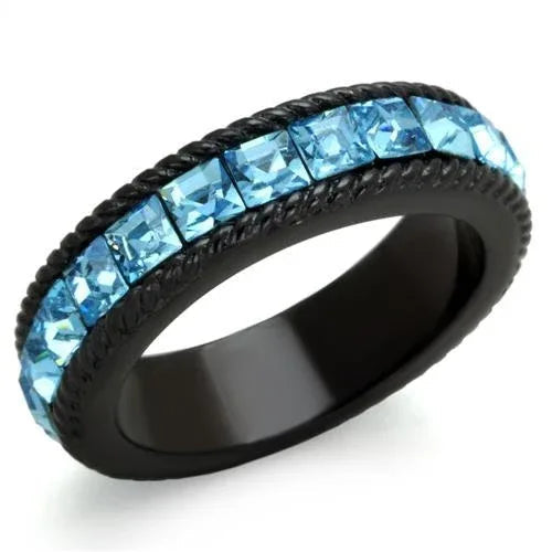 Black ion plated stainless steel ring with sea blue crystal center stone angled on reflective surface.