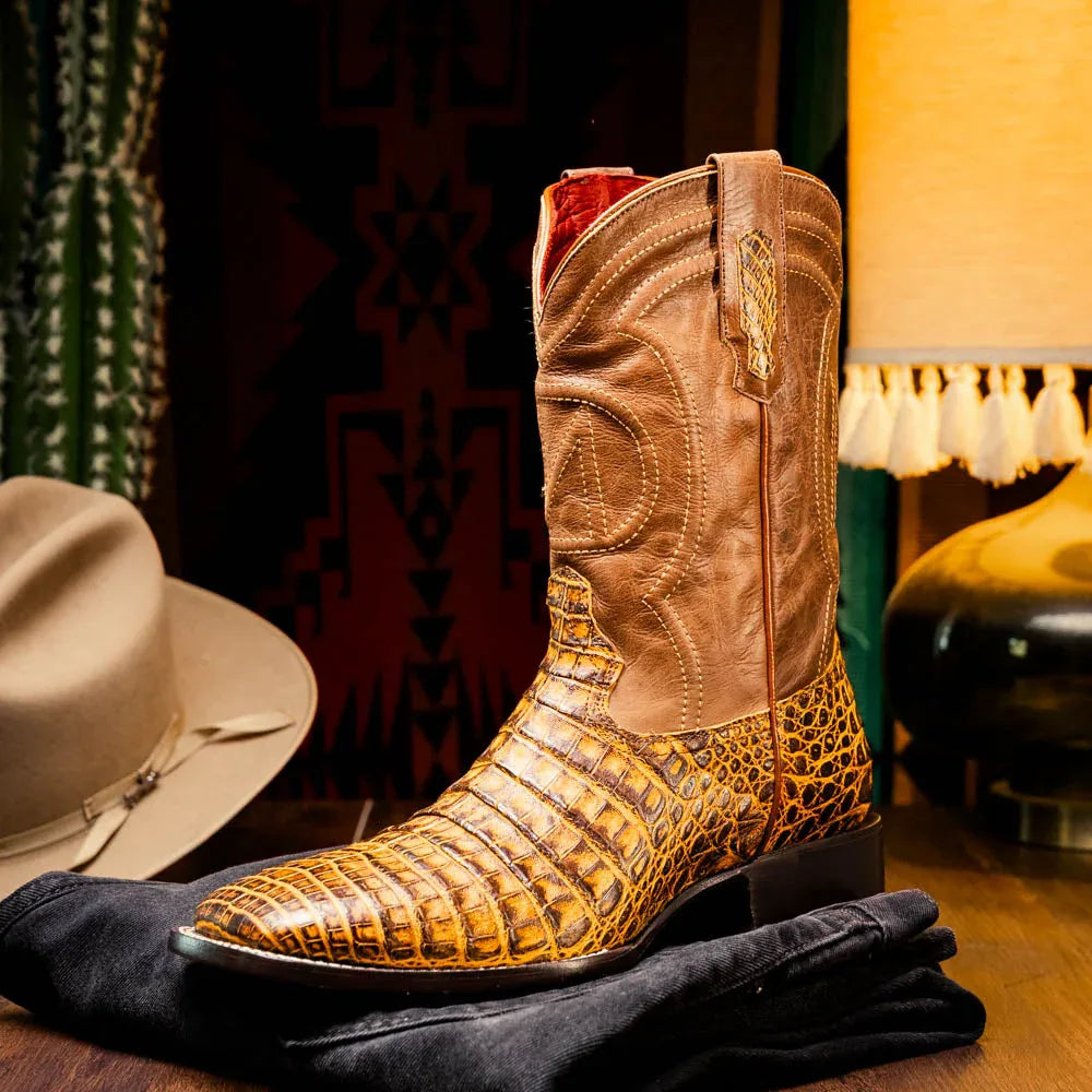 Man wearing Tucson Mustard Brown cowboy boots with jeans in an urban street setting.