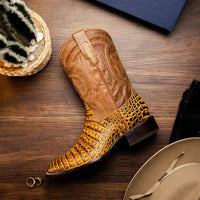 Tucson Mustard Brown boot resting on wooden surface showcasing square toe and detailed leather.