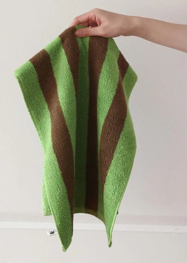 Soft, absorbent bath towel with bold retro stripes displayed against plain backdrop.