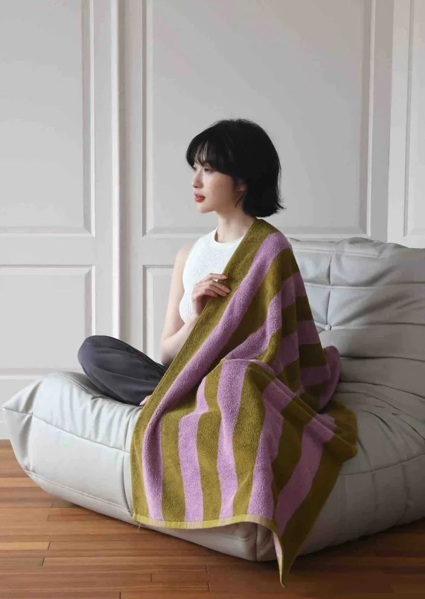 Ultra soft retro stripe bath towel in vibrant dopamine colors folded on a flat surface.