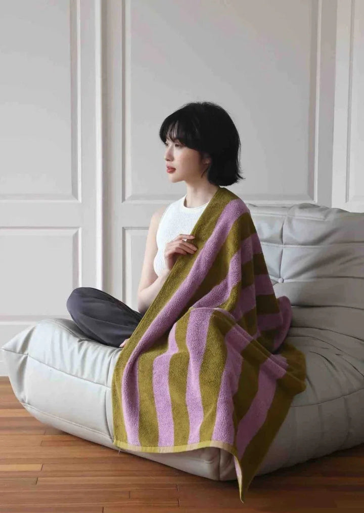 Ultra soft retro stripe bath towel in vibrant dopamine colors folded on a flat surface.