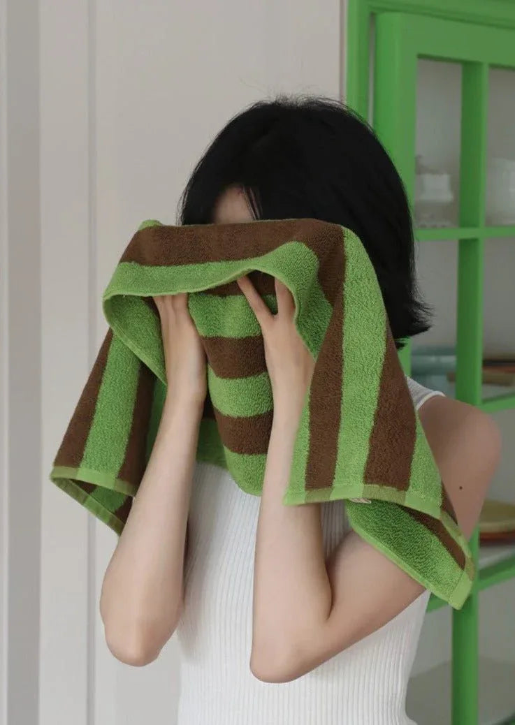 Close-up of plush organic cotton bath towel with bold colorful retro stripes.
