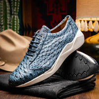 Person sitting on steps wearing stylish navy ostrich leather sneakers with white rubber soles.