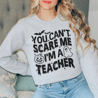 Sport grey sweatshirt with white bold text 'You Can't Scare Me I'm A Teacher' printed on front.